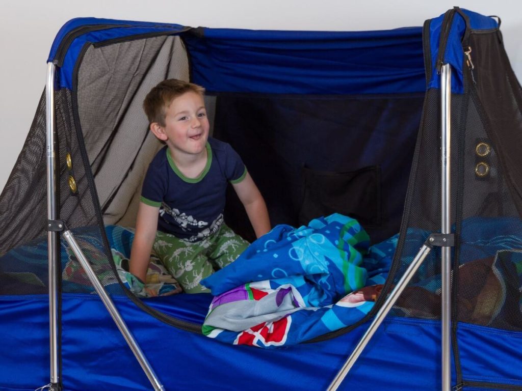 Young boy with special needs in his Safety Sleeper bed covered by insurance